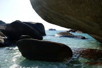 giant boulders on the sea beach against the background of the turquoise sea