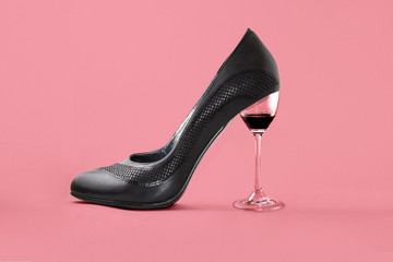 A glass of wine replaces the heel of the Shoe. the concept of femininity, freedom, and celebration.