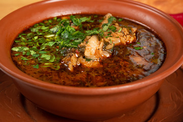 plate with traditional Georgian kharcho soup. Close-up of a bowl of soup
