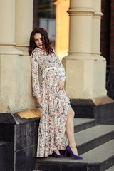 Beautiful girl walking on the street in spring. Young woman enjoying spring weather weather.
