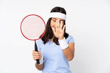 Young badminton player woman over isolated white background making time out gesture