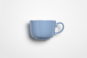 Blue ceramic mug empty blank for coffee or tea isolated on white background.Mock-up.High-resolution photo.