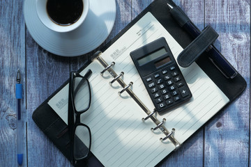 high angle view of open diary, and calculator on table 