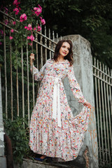 Fototapeta premium Girl in a beautiful dress park in a flower