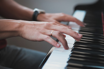 Detail of hands playing the piano