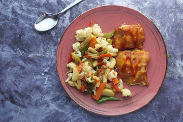 Baked salmon fish fillet with fresh salad top view.