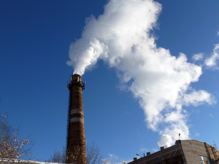 Chimney smoke with blue sky