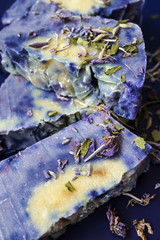 Hand made lavender soaps on the blue background. Natural cosmetic. Home business. Voluntary Isolation. Zero waste