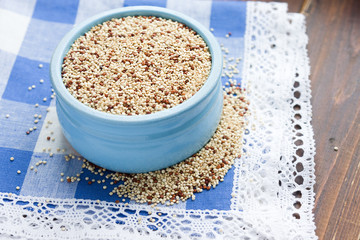 Organic quinoa grains in blue ceramic bowl, Gluten free. Concept Healthy food. Seeds of Chenopodium quinoa