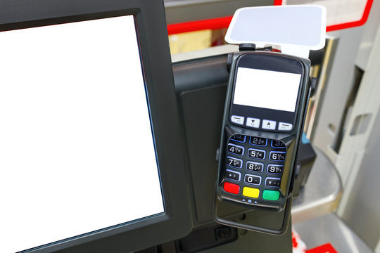 Credit card reader or pos terminal with copy space on the screen in a supermarket. On the left, there is a monitor screen with copy space. The concept of mobile payment.