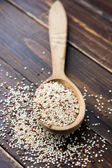 Organic quinoa grains in wooden spoon, Gluten free. Concept Healthy food. Seeds of Chenopodium quinoa