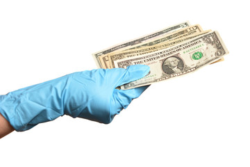 Hand in blue protective gloves with money isolated on white background.