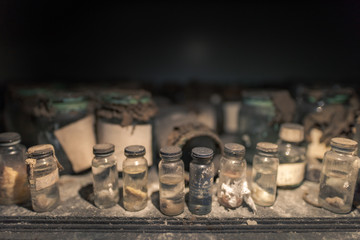 Different glass vials standing on wooden board in abandoned hospital in Pripyat, Chernobyl Exclusion Zone