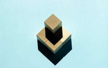 five wooden cubes on a blue background with a shadow home insurance property