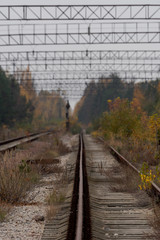 Empty abandoned train tracks leading into the distant vanishing point in Pripyat, Chernobyl...