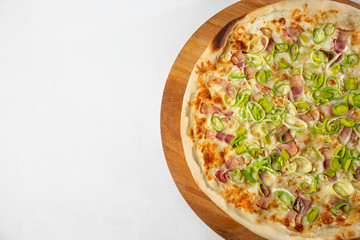 italian pizza with bacon and onions on a white plate