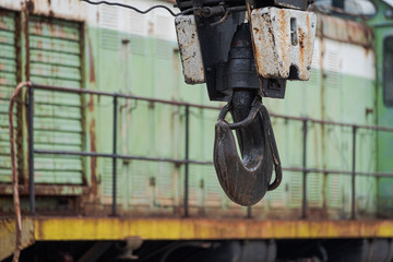 Big metal hook of crane waggon with blurred diesel locomotive in background in Pripyat, Chernobyl...