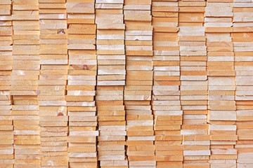 Wooden planks in the warehouse. The ends of the boards.