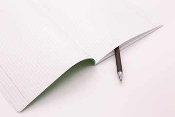 Checkered notebook and fountain pen on a white background
