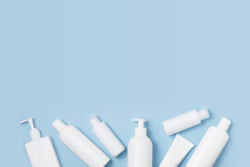 White cosmetic jars on a blue background. Cosmetics for skin care.