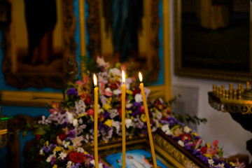 three burning candles in the church
