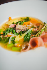soup with vegetables and prosciutto