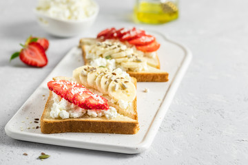 Strawberry banana rocotta honey toasts. Selective focus, copy space.