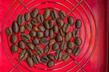 roasted coffee beans on red background.