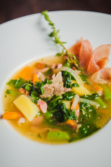 soup with vegetables and prosciutto