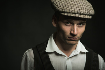 Portrait of a serious young man, sitrasec directly into the camera. Retro costume. Historical reconstruction