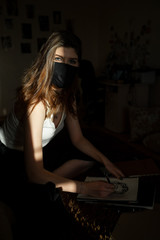 Obraz na płótnie Canvas the sun's rays fall on a girl in a black mask