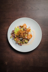 mix salad with shrimps, orange and onion fries