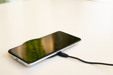 Smartphone wireless charging on induction charger. Wireless charger.