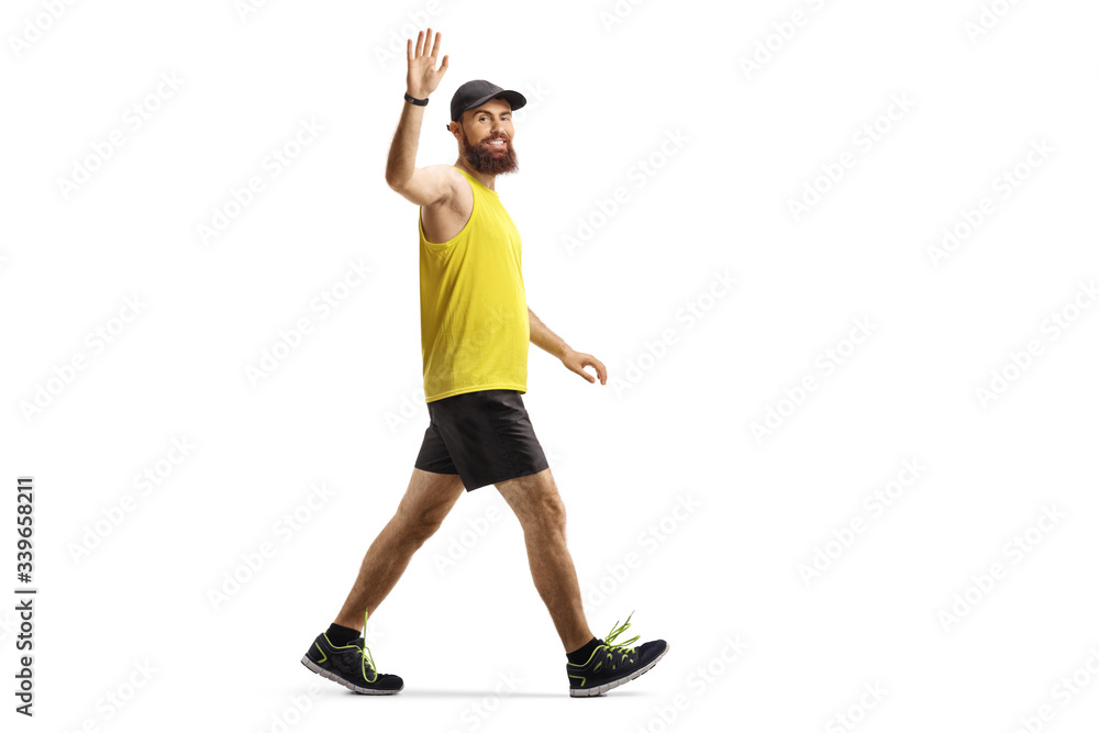 Sticker Bearded man in sportswear walking and waving at camera