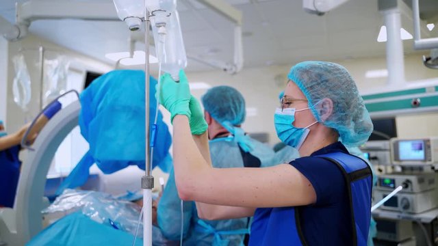 Medical procedure in emergency room. Surgical team performing surgery in modern operation theater