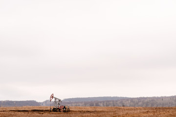 Green Oil pump oil rig energy industrial machine for petroleum crude. oil crisis. Russia pumps oil...