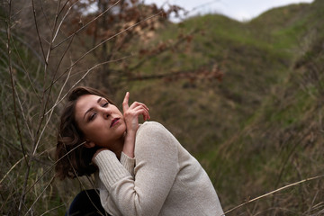 Beautiful girl in the canyon in the reeds, fashion shooting outdoors