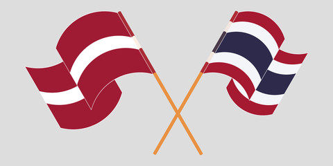 Crossed and waving flags of Latvia and Thailand