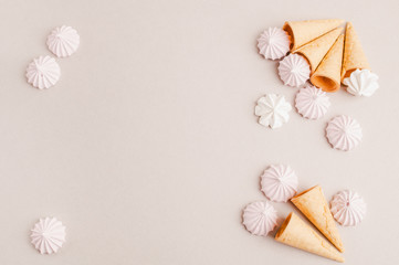 Small crispy waffle ice cream cups with colored marshmallows on a pastel background