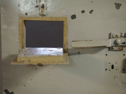 Close-up Of Open Window On Metallic Door At Prison