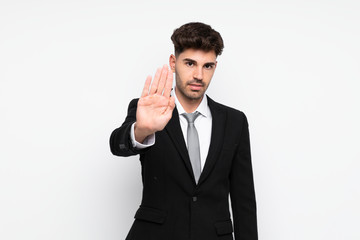 Young businessman over isolated white background making stop gesture with her hand