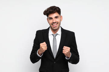 Young businessman over isolated white background celebrating a victory