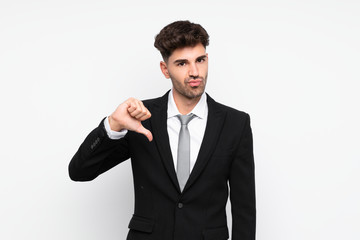 Young businessman over isolated white background showing thumb down sign