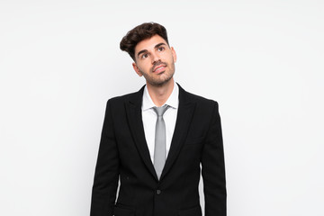 Young businessman over isolated white background laughing and looking up