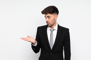 Young businessman over isolated white background holding copyspace imaginary on the palm