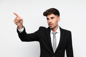Young businessman over isolated white background pointing away