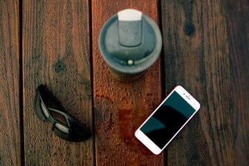 middle-aged man exercising on a bicycle in a park by a lake in the summer at sunrise