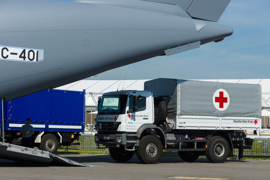 BERLIN, GERMANY - MAY 21, 2014: A car with the humanitarian aid of the German Red Cross prepares for loading into military transport aircraft Airbus A400M Atlas. Exhibition ILA Berlin Air Show 2014