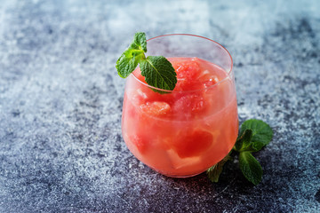 Ruby red grapefruit cocktail with mint leaves in glasses