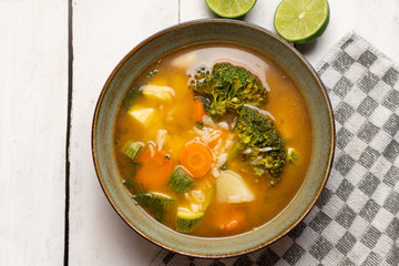 Vegetables soup with rice on white background